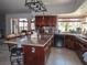 Spacious kitchen with wood cabinets, island, granite counters, and stainless appliances at 7660 Descanso Ln, Las Vegas, NV 89123