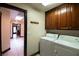 Well-lit laundry room with ample cabinet space and easy access to other areas of the home at 7660 Descanso Ln, Las Vegas, NV 89123