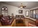 Well-lit living room featuring hard wood floors, comfortable seating, and ceiling fan at 7660 Descanso Ln, Las Vegas, NV 89123