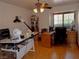 Bright home office with hardwood floors, large windows, and plenty of desk space at 7660 Descanso Ln, Las Vegas, NV 89123