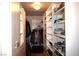 Walk-in closet featuring custom shelving and ample storage space for clothing and accessories at 7660 Descanso Ln, Las Vegas, NV 89123