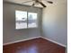 Bedroom featuring wood flooring, a large window, and a ceiling fan at 805 Slayton Dr, Las Vegas, NV 89107