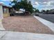 View of the residence showcasing the desert landscaping and mature shade tree at 805 Slayton Dr, Las Vegas, NV 89107