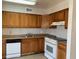 Kitchen boasts wood cabinets, white appliances, and ample counter space at 805 Slayton Dr, Las Vegas, NV 89107