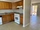 Kitchen boasts wood cabinets, white appliances, and tile flooring at 805 Slayton Dr, Las Vegas, NV 89107