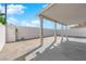 Covered back patio featuring a light-colored concrete pad and stone pavers in the backyard at 8127 Chambersberg St, Las Vegas, NV 89147