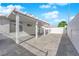 Wide angle shot of the back of the house and covered patio featuring concrete and stone pavers at 8127 Chambersberg St, Las Vegas, NV 89147