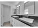 Bathroom boasts a double vanity with black granite countertops, modern faucets and ample storage at 8127 Chambersberg St, Las Vegas, NV 89147