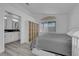 Bright bedroom with hardwood floors, large window, and closet organizer with wicker baskets at 8127 Chambersberg St, Las Vegas, NV 89147