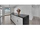 Modern kitchen with a granite island, white cabinets, and stainless appliances, seamlessly connecting to the living area at 8127 Chambersberg St, Las Vegas, NV 89147