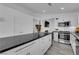 Modern kitchen featuring a large island, white cabinetry, and stainless steel appliances at 8127 Chambersberg St, Las Vegas, NV 89147
