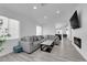 Bright living room with a comfortable gray sofa, modern fireplace, and wood-look floors at 8127 Chambersberg St, Las Vegas, NV 89147