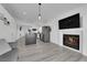 Open-concept living area with fireplace, kitchen with island, and access to the backyard at 8127 Chambersberg St, Las Vegas, NV 89147