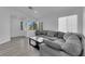 Living room featuring neutral tones, stylish sectional, and views of the entryway at 8127 Chambersberg St, Las Vegas, NV 89147