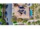 Aerial view showcases a home with solar panels, tile roof, swimming pool, and lush landscaping at 884 Loma Bonita Pl, Las Vegas, NV 89138
