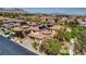 Expansive aerial view of a desert community featuring tile-roofed homes and meticulously landscaped yards at 884 Loma Bonita Pl, Las Vegas, NV 89138