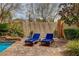 Backyard featuring blue lounge chairs beside the pool and bamboo shades for privacy at 884 Loma Bonita Pl, Las Vegas, NV 89138
