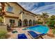 Beautiful backyard with outdoor lounge chairs, a swimming pool, and a cozy jacuzzi at 884 Loma Bonita Pl, Las Vegas, NV 89138
