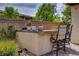 Outdoor bar and seating area is surrounded by lovely plants and landscaping at 884 Loma Bonita Pl, Las Vegas, NV 89138