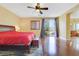 Spacious bedroom with hardwood floors, ceiling fan, and en suite bathroom at 884 Loma Bonita Pl, Las Vegas, NV 89138