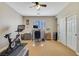 This bedroom has carpet flooring, a ceiling fan, exercise equipment and a large window at 884 Loma Bonita Pl, Las Vegas, NV 89138