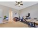 This bedroom has carpet flooring, a ceiling fan, exercise equipment and furniture at 884 Loma Bonita Pl, Las Vegas, NV 89138