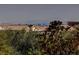 This distant city view looks out over lush landscaping and terra cotta rooftops at 884 Loma Bonita Pl, Las Vegas, NV 89138