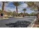 Gated community entrance with palm trees, stone accents, and lush landscaping at 884 Loma Bonita Pl, Las Vegas, NV 89138