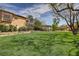 Expansive community green space offers a serene setting with mature trees and lush landscaping at 884 Loma Bonita Pl, Las Vegas, NV 89138