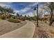 Beautifully landscaped community walkway with mature trees, providing a peaceful environment for residents at 884 Loma Bonita Pl, Las Vegas, NV 89138