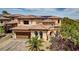 Stunning two-story home with tile roof, arched windows, and a three-car garage at 884 Loma Bonita Pl, Las Vegas, NV 89138
