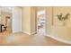 Hallway with carpeted floors, yellow walls, and doorways to bedrooms, bathrooms and closets at 884 Loma Bonita Pl, Las Vegas, NV 89138