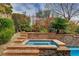 Outdoor stone hot tub and lush landscaping is located in this backyard at 884 Loma Bonita Pl, Las Vegas, NV 89138