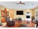 Cozy living room with a fireplace, entertainment center, and stylish furniture at 884 Loma Bonita Pl, Las Vegas, NV 89138