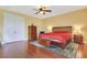 Well-lit main bedroom featuring hardwood floors, closet and ceiling fan at 884 Loma Bonita Pl, Las Vegas, NV 89138