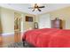 This bright main bedroom features wood floors, fan, large closet and television at 884 Loma Bonita Pl, Las Vegas, NV 89138