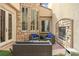 Beautiful outdoor patio with stone fireplace, comfortable seating, and garden view at 884 Loma Bonita Pl, Las Vegas, NV 89138