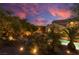 Landscaped backyard oasis with mature trees, string lights, outdoor seating, and serene ambiance at dusk at 9 Chalet Hills Ter, Henderson, NV 89052