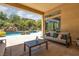 Lush backyard oasis featuring a tranquil pool, mature trees, and rock waterfall at 9 Chalet Hills Ter, Henderson, NV 89052