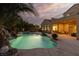 Lush backyard pool with waterfall and outdoor lounge area offering a luxurious and private escape at 9 Chalet Hills Ter, Henderson, NV 89052