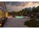 Backyard with a pool, spa, and lush landscaping, offering a private oasis perfect for relaxation and entertainment at 9 Chalet Hills Ter, Henderson, NV 89052