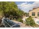 Inviting backyard with comfortable seating, mature trees, and partial view of the house, ideal for relaxing and entertaining at 9 Chalet Hills Ter, Henderson, NV 89052