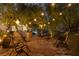 Cozy backyard patio with ambient lighting, comfortable seating, and mature trees for private outdoor gatherings at 9 Chalet Hills Ter, Henderson, NV 89052