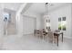 Open dining room featuring modern chandelier and ample seating and staircase at 9 Chalet Hills Ter, Henderson, NV 89052