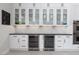 Elegant kitchen with white cabinets, wine refrigerators, and modern finishes at 9 Chalet Hills Ter, Henderson, NV 89052