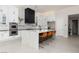 Modern kitchen with white cabinets, large island with seating, and stainless-steel appliances at 9 Chalet Hills Ter, Henderson, NV 89052
