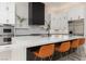 Modern kitchen with marble island, stainless steel appliances, and white cabinets at 9 Chalet Hills Ter, Henderson, NV 89052