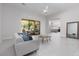 Spacious living room with a stylish gray sofa, modern coffee table, and plenty of natural light at 9 Chalet Hills Ter, Henderson, NV 89052