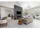 Bright living room featuring a large modern fireplace, stylish furniture, and a door to the yard at 9 Chalet Hills Ter, Henderson, NV 89052