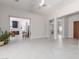 Open-concept living space with gray tile floors, modern fixtures, and an entryway to the kitchen at 9 Chalet Hills Ter, Henderson, NV 89052